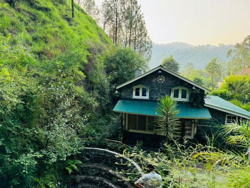 a small house on the side of a hill at Hidden Resort Abbottabad in Abbottabad