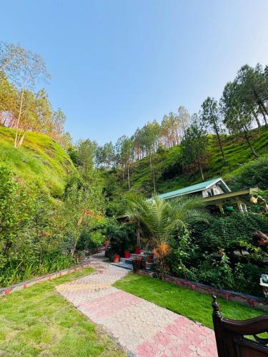 a garden with a house on a hill at Hidden Resort Abbottabad in Abbottabad