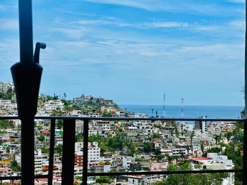 a view of a city from a balcony at Suite CasaBlanca Grand, la mejor vista de Acapulco in Acapulco