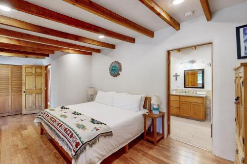 a bedroom with a bed and a bathroom at Valverdo Oasis in Taos