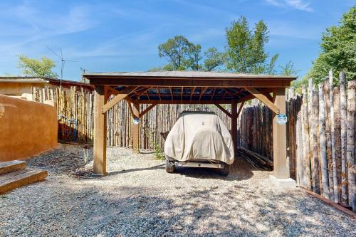 a golf cart parked under a cover in a fence at Valverdo Oasis in Taos