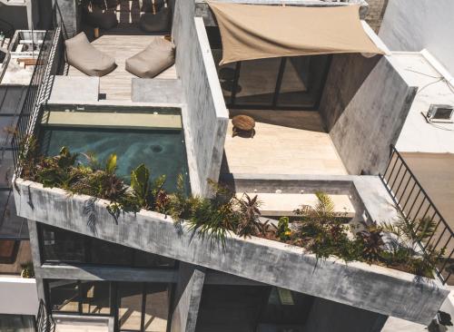 an overhead view of a building with a swimming pool at Urbano by Sundara in Tulum