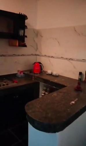 a kitchen with a marble counter top and a counter top at it is a calm place in Ghazoua