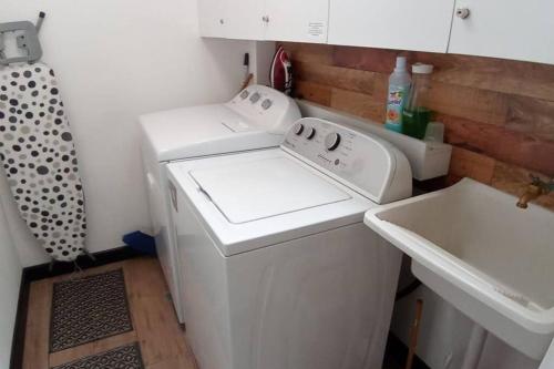 a white washer and dryer in a small kitchen at DSt4 Well stocked studio in zone 15 in Guatemala