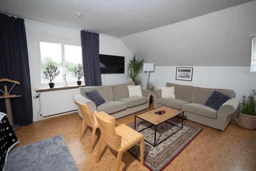 a living room with a couch and a table at Cozy loft in Anderstorp - easy living in Anderstorp