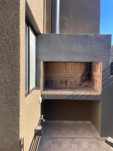 a brick oven in the side of a building at Smarthouse in Capitán Bermúdez
