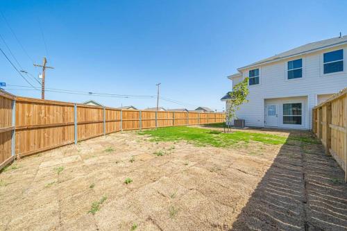 a wooden fence in front of a house at Gorgeous, Brand New 3 Bedrooms Home- Built 2024, Near SeaWorld & Lackland AFB in San Antonio