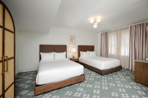 a hotel room with two beds and a television at Hotel Granada, a Design Hotel in Atlanta