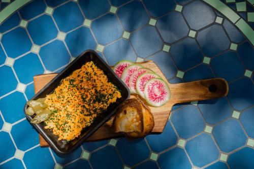 a table with a tray of food with bread and cheese at Hotel Granada, a Design Hotel in Atlanta