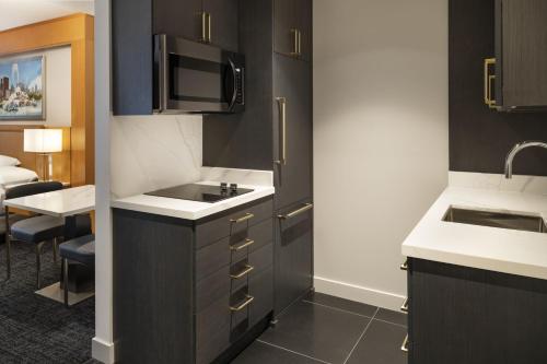 a small kitchen with a sink and a microwave at Residence Inn by Marriott Chicago Downtown Magnificent Mile in Chicago