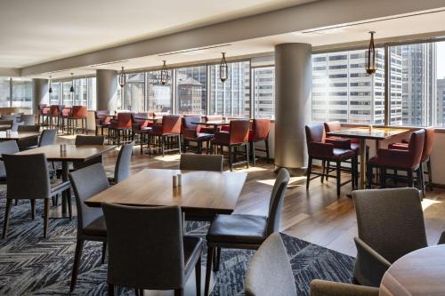 a restaurant with tables and chairs and large windows at Residence Inn by Marriott Chicago Downtown Magnificent Mile in Chicago