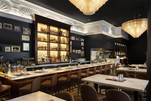 a restaurant with a long bar with tables and chairs at Residence Inn by Marriott Chicago Downtown Magnificent Mile in Chicago
