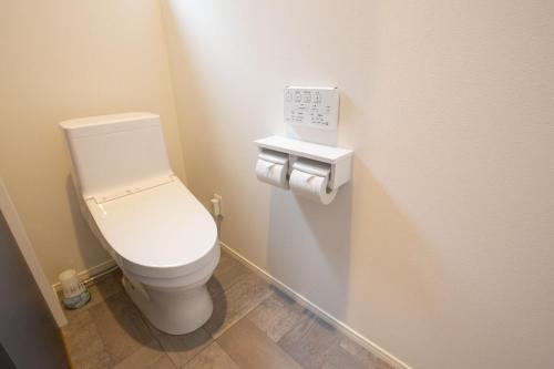 a bathroom with a white toilet in a room at ホテル森のしずく in Shimoda