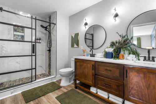 a bathroom with a shower and a toilet and a sink at 4BD with BBQ & Games - Duke, NCCU and Downtown Nearby in Durham