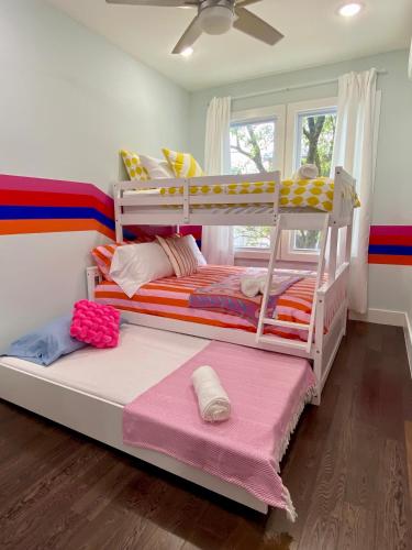 a bedroom with two bunk beds and a window at Heart of NY - 17 min to Empire State & Times Sq in Jersey City