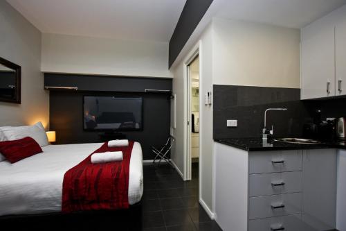 a hotel room with a bed and a sink at Jesmond Executive Villas in Newcastle
