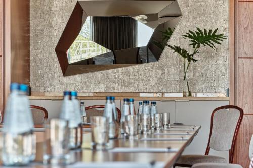 a table in a restaurant with a mirror at The Westin Warsaw in Warsaw