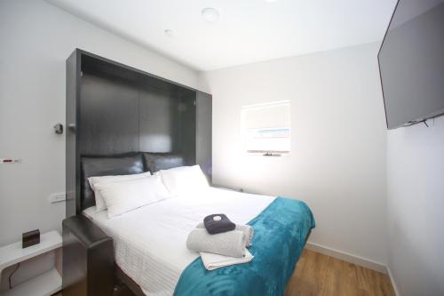 a bedroom with a bed with a hat on it at Jesmond Executive Villas in Newcastle
