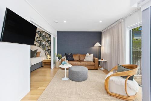 a living room with a couch and a tv at The Sand Resort Kingscliff - Holiday Management Co. in Kingscliff