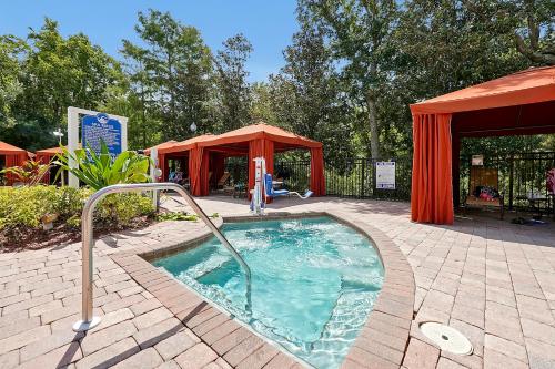 a small swimming pool in a patio with a tent at Awesome Mediterranean Resort! 15 minutes to Disney in Kissimmee