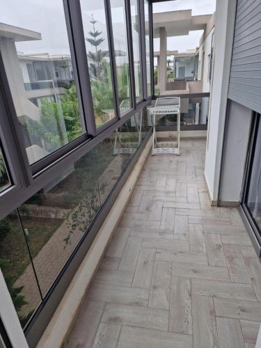 an empty balcony with a table and windows at 2 bedroom appart at the beach in gated community with pool in Sidi Rahal