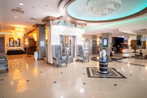 a lobby with chairs and a table in a building at Holiday Inn Orlando East-UCF Area by IHG in Orlando