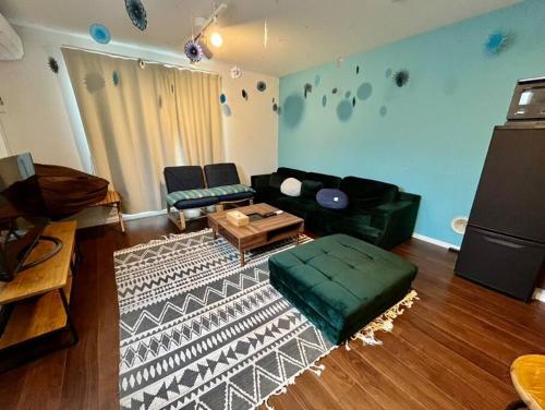 a living room with a couch and a table at Rakuna Inn 動 Sasazuka in Tokyo