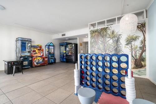 a play room with a blue and white game at Rolling Surf Resort in Caloundra