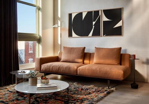 a living room with a couch and a table at Archway Hotel Residence in Philadelphia