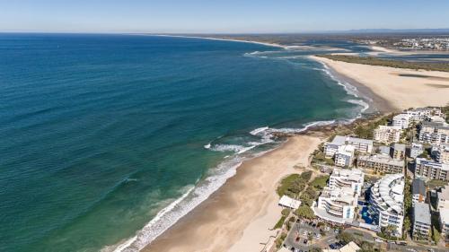 an aerial view of the beach and the ocean at Rolling Surf Resort in Caloundra