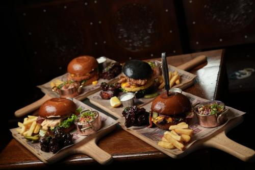 a group of sandwiches and fries on a table at Crowne Plaza Dubai Festival City in Dubai