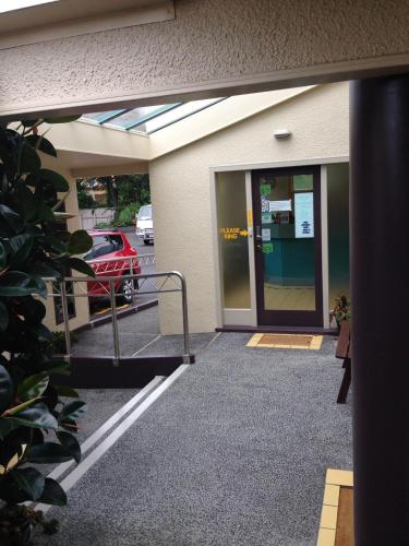 an entrance to a parking lot with a glass door at Penny's B&B Accommodation in Palmerston North