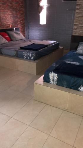 two beds sitting next to each other in a room at City hotel in Sibu
