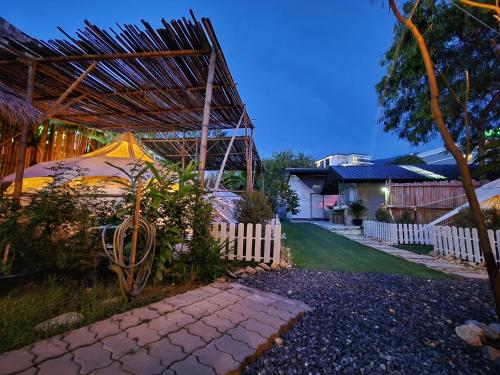 a backyard with a tent and a fence at Bambus Restaurant, Bar & Glamping in Patong Beach
