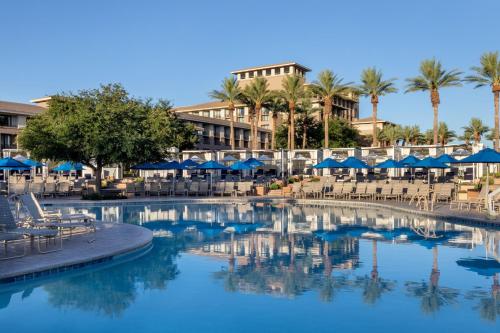 a pool at a resort with chairs and umbrellas at The Westin Kierland Resort & Spa in Scottsdale