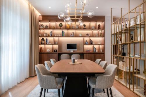 a dining room with a table and chairs at AC Hotel by Marriott Clodio Roma in Rome