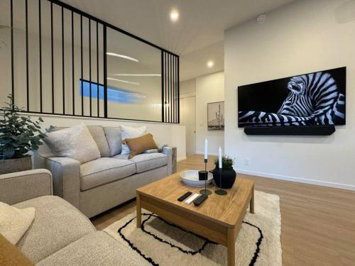 a living room with a couch and a zebra on the wall at Casa Bramble Luxury 2Bed Suite near UofA Hospital in Edmonton