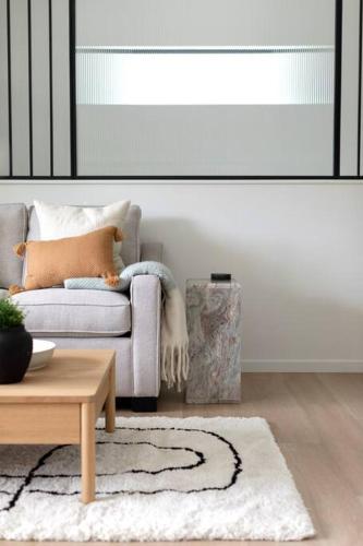 a living room with a couch and a table at Casa Bramble Luxury 2Bed Suite near UofA Hospital in Edmonton