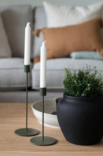 two candles and a vase on a table at Casa Bramble Luxury 2Bed Suite near UofA Hospital in Edmonton