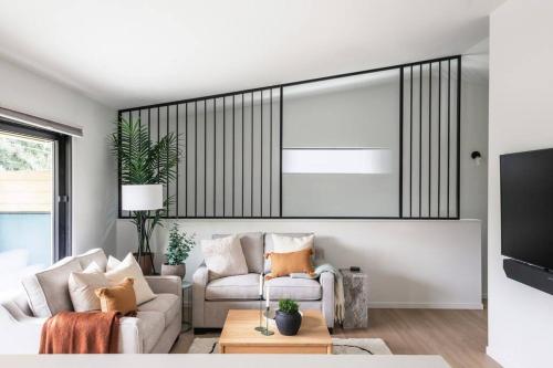 a living room with a couch and a tv at Casa Bramble Luxury 2Bed Suite near UofA Hospital in Edmonton