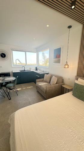 a living room with a bed and a couch at Penthouse in Mellieha with Private Pool & Large Terraces in Mellieħa