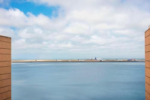 a view of an airport runway with planes in the distance at San Francisco Airport Marriott Waterfront in Burlingame