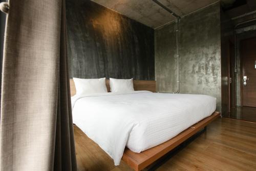 Ένα ή περισσότερα κρεβάτια σε δωμάτιο στο Navakitel Design Hotel