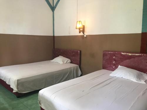 Postel nebo postele na pokoji v ubytování Rinjani Terrace Cottage