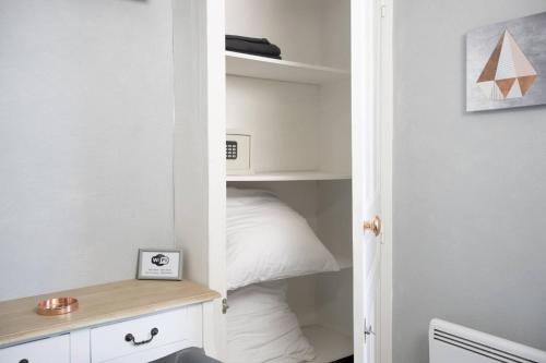 Cette chambre comprend un placard avec un lit et un bureau. dans l'établissement Studio cosy à Clermont-Ferrand 25 m² proche transport, à Clermont-Ferrand