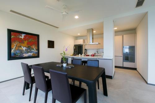 a kitchen and dining room with a black table and chairs at The Heights Penthouse A5 3Bedrooms Seaview near Kata Beach in Kata Beach