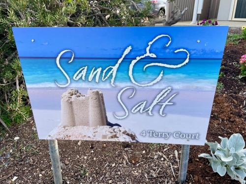 a sign for a beach resort with the words sand and salt at Sand & Salt in Kingscote
