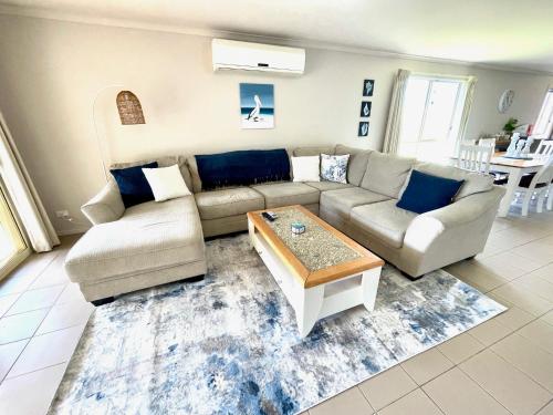 a living room with a couch and a coffee table at Sand & Salt in Kingscote