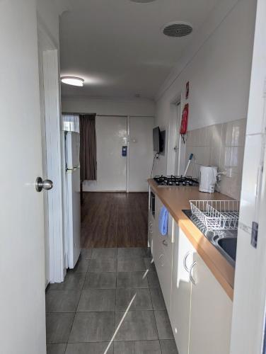 a kitchen with a sink and a counter top at Ocean Drive Motel in Bunbury