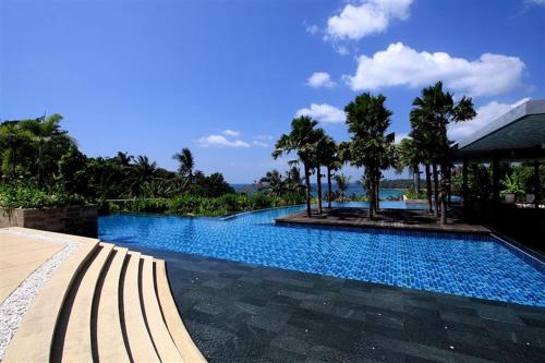 a large swimming pool with trees and a building at The Heights Penthouse A5 3Bedrooms Seaview near Kata Beach in Kata Beach